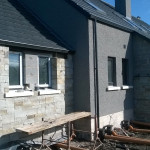 grey stone rendered walls with sewage pipes