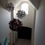 3 large chandeliers in large open hallway