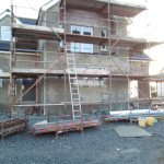 Finished plastered house with scaffolding and ladder in front