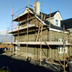House with scaffolding getting plastered